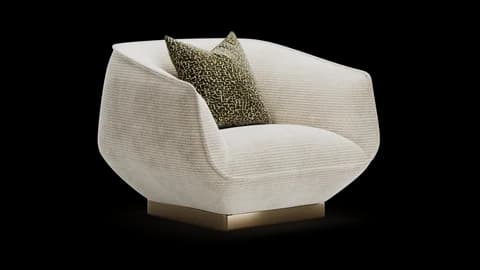 Rounded cream armchair with an olive patterned cushion on a low brass plinth
