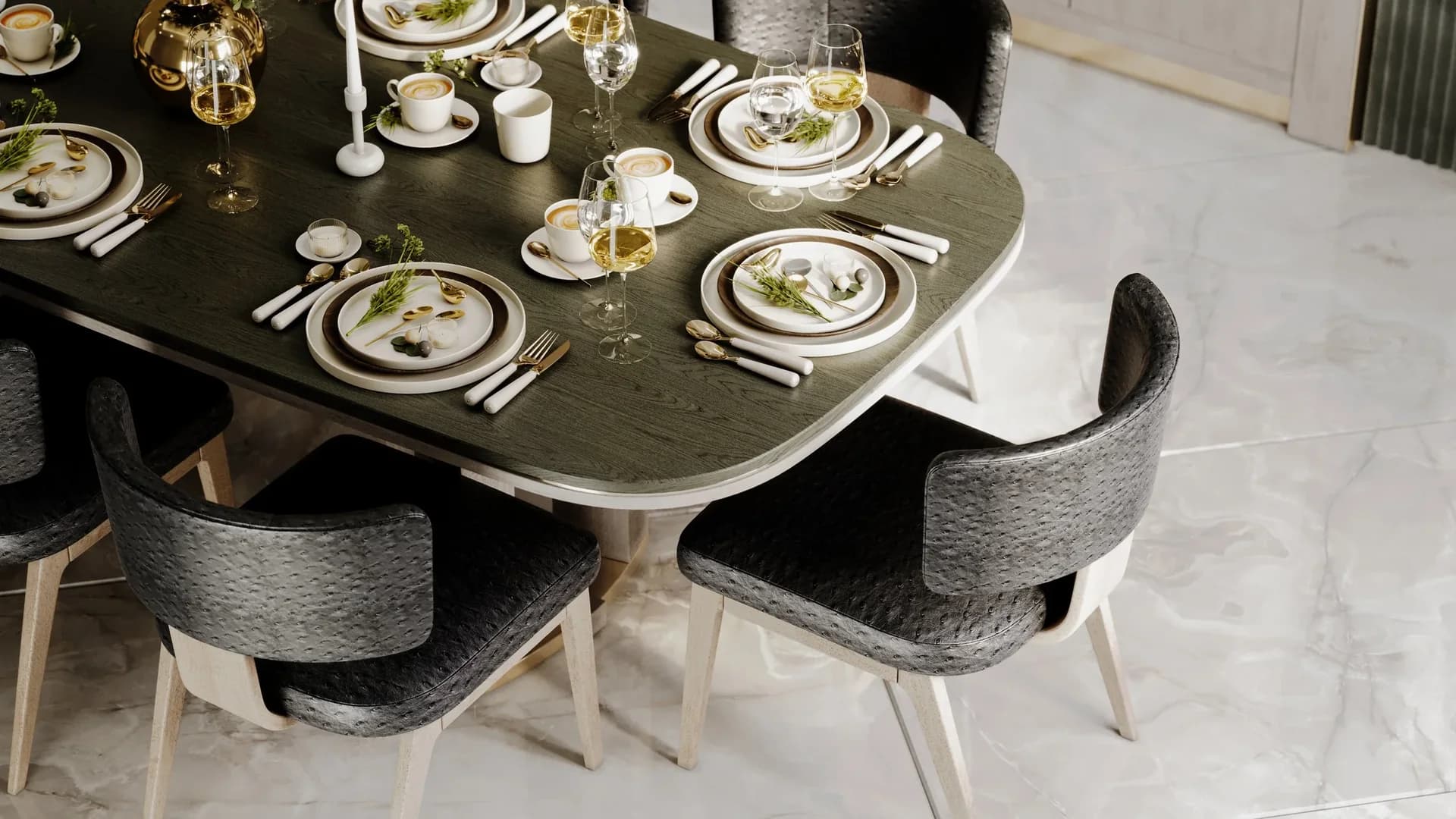 Close view of a dark wood-grain dining table with a pale edge, charcoal upholstered chairs and white place settings.