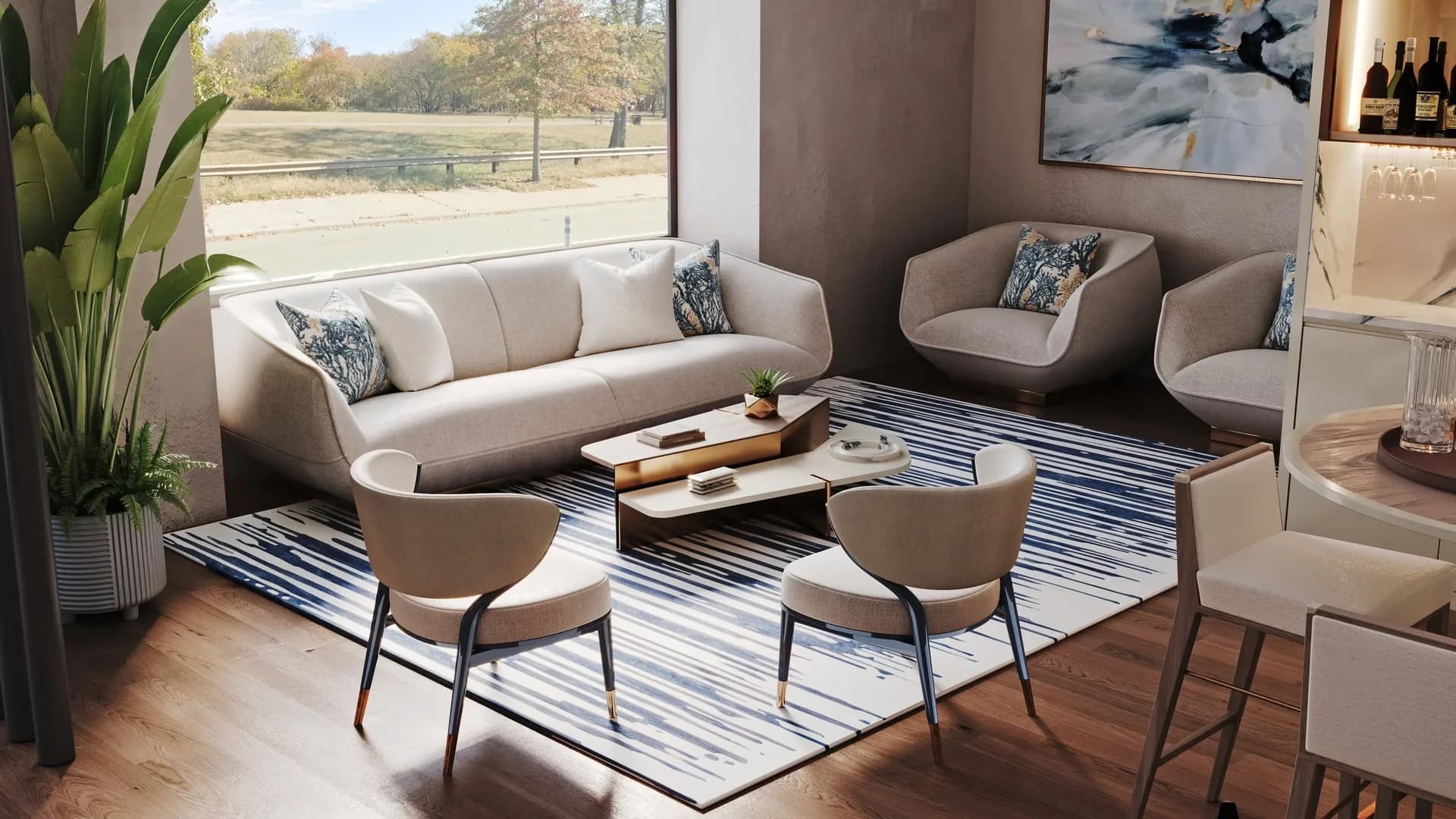 Pale rounded sofa and armchairs arranged on a blue-and-white rug beside a large showroom window.
