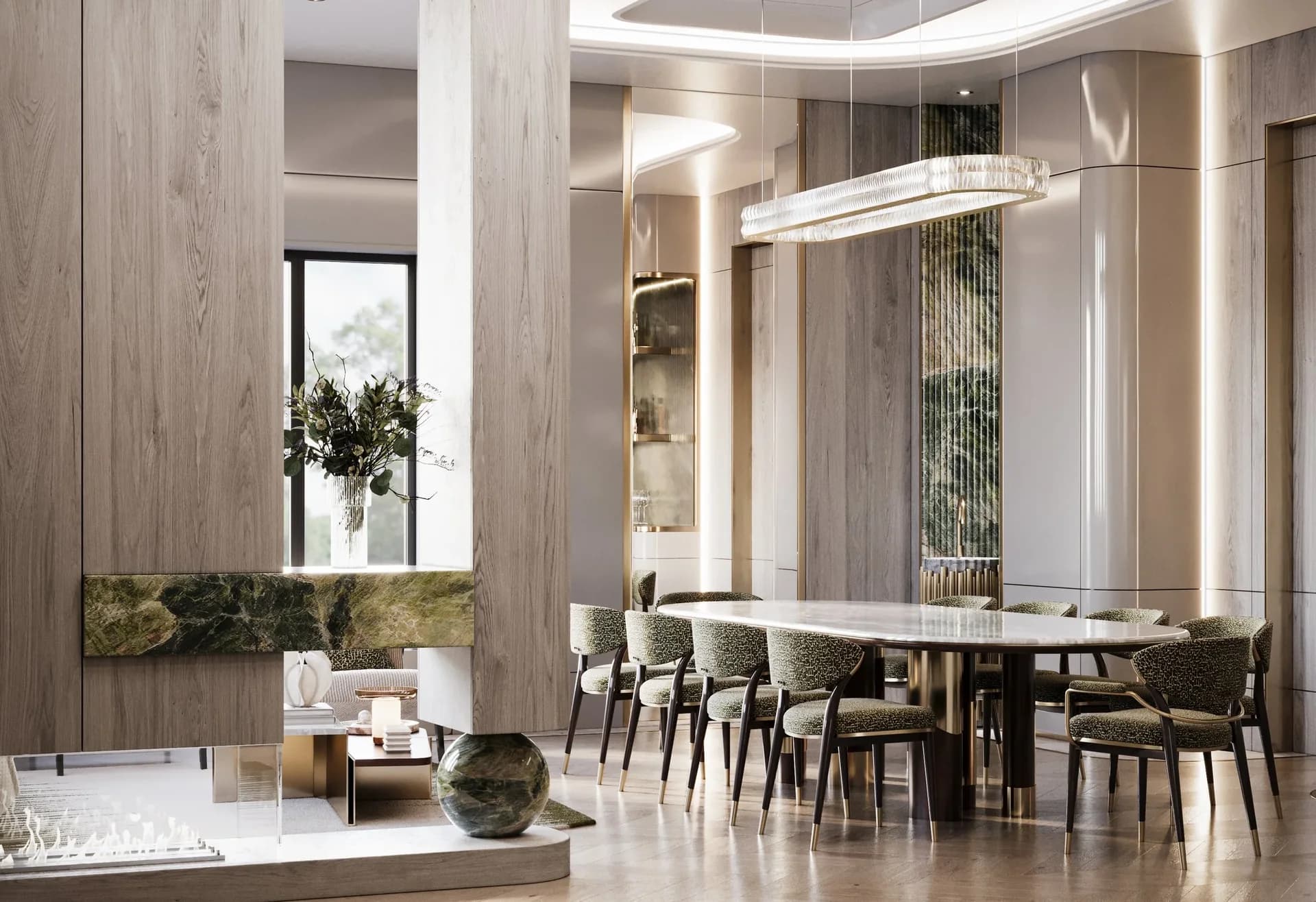 A London dining room: pale timber panelling, a band of veined green stone, a long glass pendant and an oval stone table ringed with green upholstered chairs